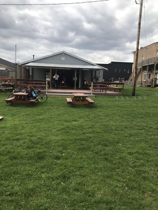 The back of Odie's from the lawn, picnic tables out on the grass