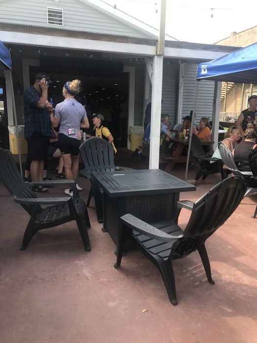 The covered patio with Adirondack chairs and a fire table