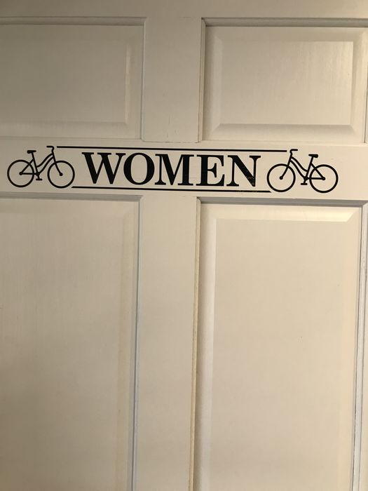 The women's restroom door, marked with a pair of bicycles