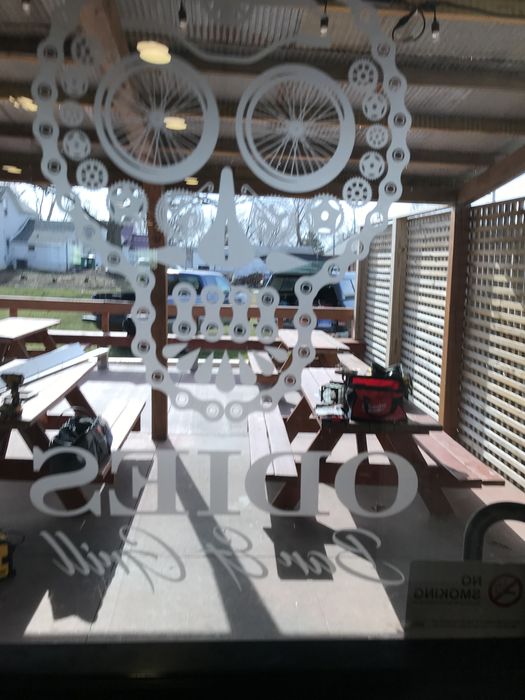 The Odie's skull-and-bicycle logo etched in the front window